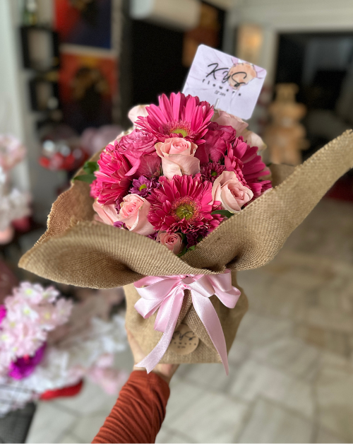 arreglo en base de madera con rosas y gerberas